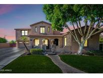 Charming two-story home boasts a landscaped front yard and a welcoming entrance with arched detailing at 2282 E Zion Way, Chandler, AZ 85249