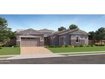 Charming single-story home with a stone-accented facade, manicured lawn, and a two-car garage, perfect for modern living at 23037 E Nightingale Rd, Queen Creek, AZ 85142