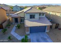 Beautiful two-story home featuring desert landscaping and a two-car garage in a suburban neighborhood at 25806 W Hilton Ave, Buckeye, AZ 85326