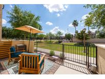 Inviting patio with comfortable seating and serene views of the community green space at 2628 S Voyager Dr # 104, Gilbert, AZ 85295