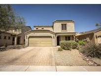 Charming two-story home with a well-manicured front yard, desert landscaping, and a two-car garage at 29110 N 24Th Ln, Phoenix, AZ 85085