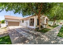 Charming single-story home with a well-manicured lawn, two car garage and a beautiful shade tree in the front yard at 3030 E Camellia Dr, Gilbert, AZ 85296