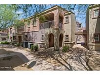 Beautiful townhome featuring stucco finish, balcony, gated entrance, and low maintenance landscaping at 3935 E Rough Rider Rd # 1164, Phoenix, AZ 85050