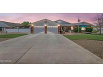 Charming single-story home with a brick facade, a spacious driveway, and a well-maintained lawn and front yard at 4304 W Calle Poco --, Laveen, AZ 85339