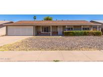 Charming single-story home featuring a well-kept lawn, attached garage, and neutral-toned exterior at 548 W Linda Ln, Chandler, AZ 85225