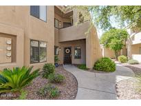 Inviting condo entrance with well-maintained landscaping and a charming walkway to the front door at 7575 E Indian Bend Rd # 1142, Scottsdale, AZ 85250