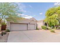 Home exterior featuring a tile roof and a three-car garage at 9678 E Voltaire Dr, Scottsdale, AZ 85260