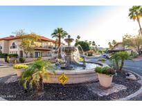 Scenic view of the community's water feature, lush landscaping and surrounding buildings at 10410 N Cave Creek Rd # 2030, Phoenix, AZ 85020