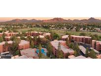 Stunning aerial view showcasing the community pool, golf course, and mountain views at 12222 N Paradise Village S Pkwy # 442, Phoenix, AZ 85032