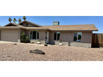 Charming single-story home boasts desert landscaping, a two-car garage, and a cozy front porch entrance at 1661 E Bishop Dr, Tempe, AZ 85282
