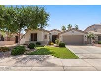 Charming single-story home with well-manicured lawn, mature trees, and inviting curb appeal at 1680 S Arroyo Ln, Gilbert, AZ 85295