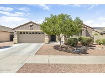 Charming single-story home with a well-manicured front yard, desert landscaping, and a spacious two-car garage at 17820 W Charter Oak Rd, Surprise, AZ 85388