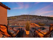 Relaxing balcony featuring lounge chairs, a table, and a scenic view of the surrounding landscape and pool at 18121 W Las Cruces Dr, Goodyear, AZ 85338