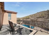Balcony featuring seating with views of the pool and desert landscape at 18121 W Las Cruces Dr, Goodyear, AZ 85338