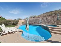 Stunning backyard pool and spa with beautiful desert landscape views at 18121 W Las Cruces Dr, Goodyear, AZ 85338