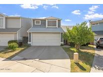 Two-story home with blue siding, white garage door, and well-maintained front yard at 18644 N 5Th Ave, Phoenix, AZ 85027