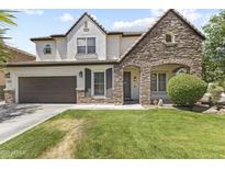 Charming two-story home with a well-maintained lawn and stone archway entrance, creating a welcoming curb appeal at 2144 E Honeysuckle Pl, Chandler, AZ 85286