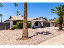 Charming single-story home with a well-manicured desert landscape and arched entryway, creating curb appeal at 2220 S Cottonwood Dr, Tempe, AZ 85282