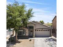 Charming single-story home with a well-maintained front yard and a two-car garage on a sunny day at 23645 W Parkway Dr, Buckeye, AZ 85326