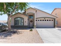Charming single-story home with a well-manicured yard and a two-car garage at 23645 W Parkway Dr, Buckeye, AZ 85326