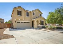 Two-story home showcasing a neutral color scheme, a two-car garage, and low maintenance desert landscaping at 23733 S 209Th Pl, Queen Creek, AZ 85142
