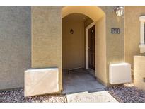 Inviting front entryway with stone facade and covered porch leading to the home's entrance with the address number above the door at 2402 E 5Th St # 1411, Tempe, AZ 85288