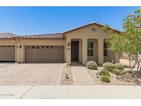 Inviting single-story home with a well-maintained yard and a charming brick walkway at 24746 N 171St Ln, Surprise, AZ 85387