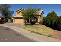 Attractive two-story home featuring a well-manicured lawn and a neutral-colored exterior at 2634 S 63Rd Dr, Phoenix, AZ 85043