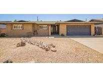 Charming single-story home with a rock lawn, mature landscaping, and a spacious driveway at 3825 W Royal Palm Rd, Phoenix, AZ 85051