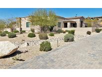 Beautiful desert home featuring decorative stone, lovely landscaping, and a winding brick paver driveway at 4008 La Ultima Piedra --, Carefree, AZ 85377