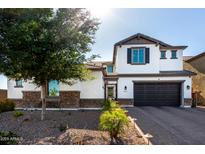 Charming two-story home featuring stone accents, a two car garage, and desert landscaping at 5212 S Seton Ct, Gilbert, AZ 85298