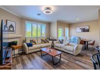 Cozy living room with plush seating, modern lighting, and a fireplace for relaxed living at 5345 E Van Buren St # 307, Phoenix, AZ 85008