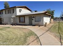 Charming single-Gathering home with a well-maintained lawn and a concrete walkway leading to the entrance at 7109 W Wolf St, Phoenix, AZ 85033