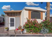 Charming single-story home with desert landscaping, shutters, and covered porch in a vibrant mobile home community at 730 S Country Club Dr # Ofc, Mesa, AZ 85210