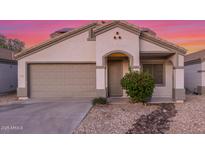 Charming single-story home with a two-car garage, desert landscaping, and neutral color palette at 7319 S 56Th Dr, Laveen, AZ 85339