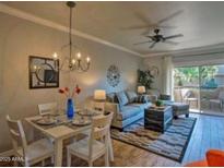Inviting dining area featuring a chandelier, dining table set for four, and access to a private outdoor patio at 9450 E Becker Ln # 2099, Scottsdale, AZ 85260