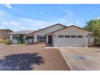 Charming single-story home featuring a well-maintained front yard and attached garage at 1020 E Concorda Dr, Tempe, AZ 85282
