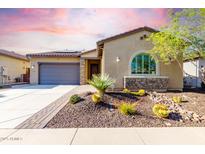 Charming single-story home features desert landscaping, a stone facade, a tile roof, and a two-car garage at 13448 W Miner Trl, Peoria, AZ 85383
