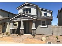 Charming two-story home with a covered front porch and stone accents on the pillars at 13489 N 158Th Ave, Surprise, AZ 85379