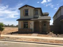 Two-story home with a covered front porch and stone accents, offering a welcoming curb appeal at 13501 N 158Th Ave, Surprise, AZ 85379