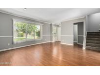 Bright living room features wood floors, and lots of natural light at 1385 N 44Th St, Phoenix, AZ 85008