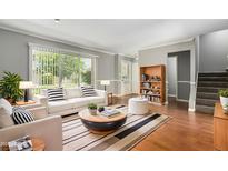 Bright living room with a white couch, decorative pillows and a large window that lets in a lot of natural light at 1385 N 44Th St, Phoenix, AZ 85008