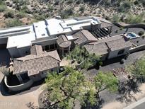Expansive estate showcasing desert landscaping, tiled roofs, private pool and spa, offering a luxurious outdoor experience at 13931 E Via Linda --, Scottsdale, AZ 85259