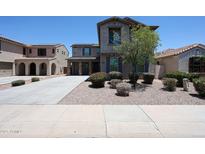Two-story home featuring desert landscaping, covered parking, and solar panels for energy efficiency at 16475 N 183Rd Dr, Surprise, AZ 85388