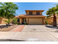 Inviting two-story home with a well-manicured lawn and a spacious two-car garage at 1723 W Mercury Way, Chandler, AZ 85224