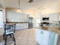 Spacious kitchen featuring stainless steel appliances, granite countertops, and tiled floors at 17371 N 86Th Ave, Peoria, AZ 85382