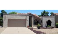 Charming single-story home with a well-manicured yard, desert landscaping, and a two-car garage at 19025 N 96Th Ave, Peoria, AZ 85382