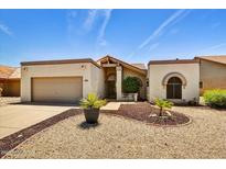 Charming single-story home featuring a well-manicured yard, desert landscaping, and a two-car garage at 19025 N 96Th Ave, Peoria, AZ 85382