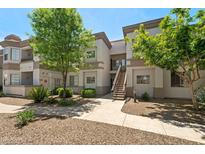 Beautiful condo building with lush green trees and well maintained landscaping at 1941 S Pierpont Dr # 2015, Mesa, AZ 85206