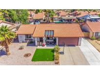 Charming single-story home featuring a red tile roof and a well-maintained front yard with green turf at 2009 W Calle Del Norte Dr, Chandler, AZ 85224